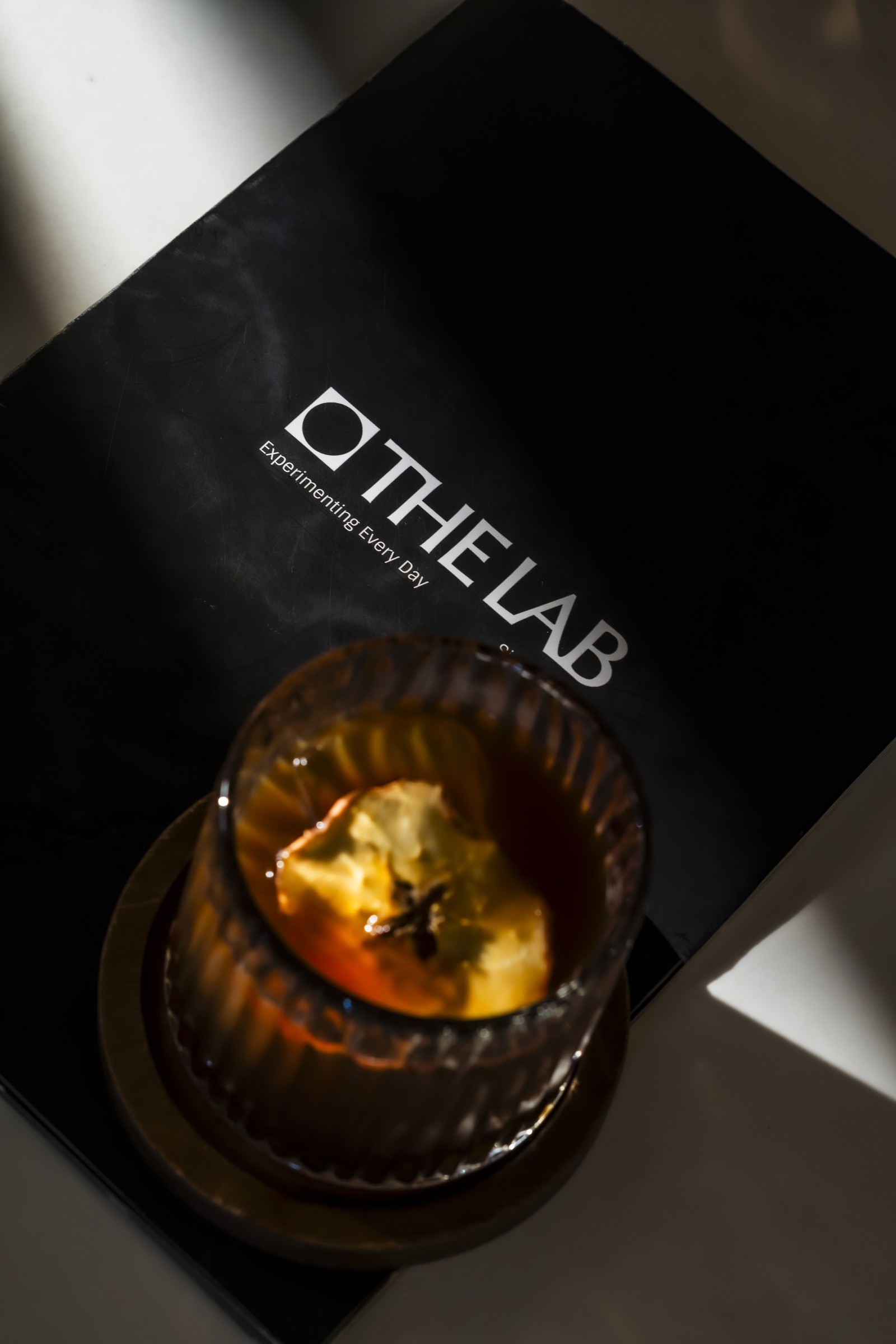 A cocktail on The Lab menu cover